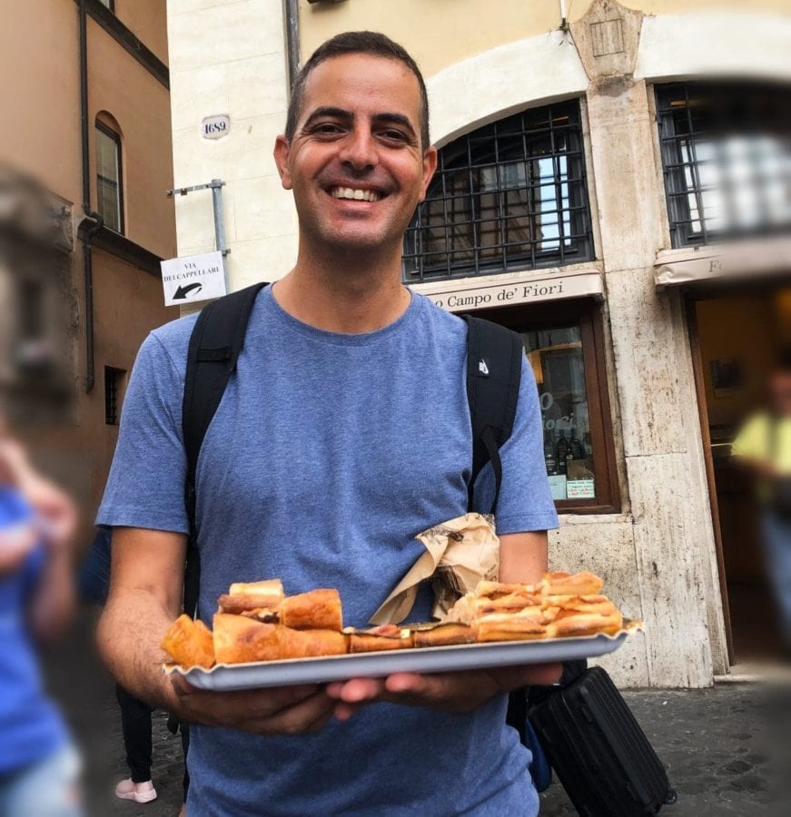 A Secret Food Tour of Rome guide delivers some pizza to his guests.