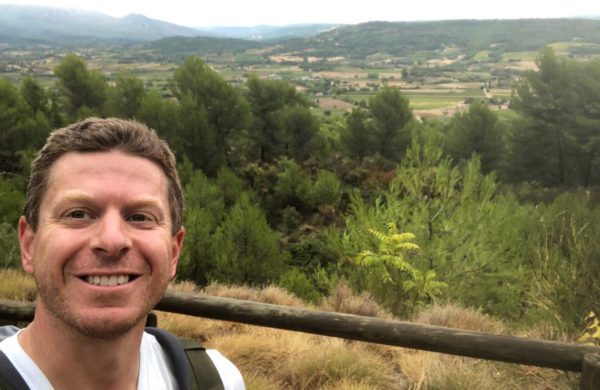 Luberon Loop author Rory Moulton poses above one of 27 perched villages through which the trail passes.